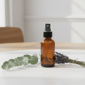 Exhale & Unwind Room Mist - amber bottle with eucalyptus and lavender props