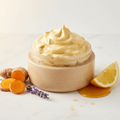 Golden Glow Body Whip in open oatmeal rice husk jar with turmeric, lavender, lemon and honey props