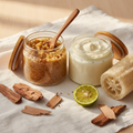 Sacred Grove Foot Ritual — glass jars with wooden lids, cedarwood, sandalwood and bergamot props on white linen