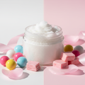 Happy Girl Body Scrub Travel Size in a clear 2oz jar with no label, with bubble gum props