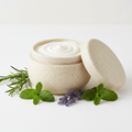 Rosemary Retreat Body Scrub in a rice husk jar with rosemary, peppermint and lavender props